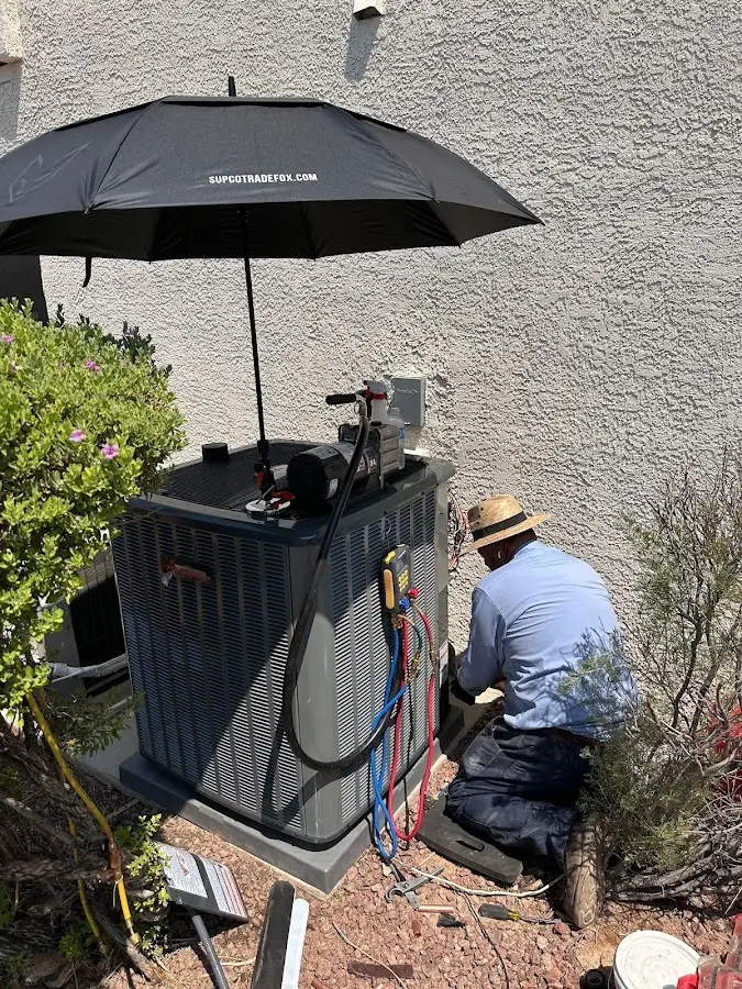 HVAC technician performing outdoor AC maintenance in Miami Springs